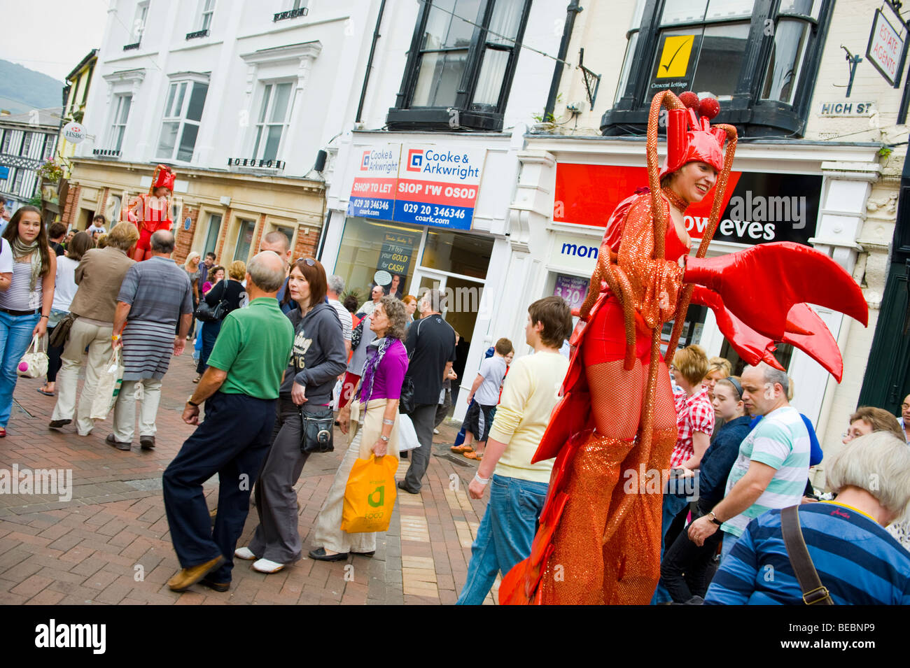 Stilt walking street performance artists dressed as lobsters at
