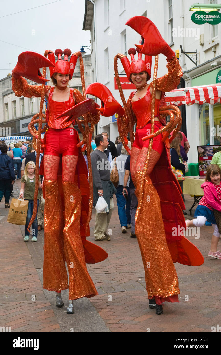 Stilt walking street performance artists dressed as lobsters at