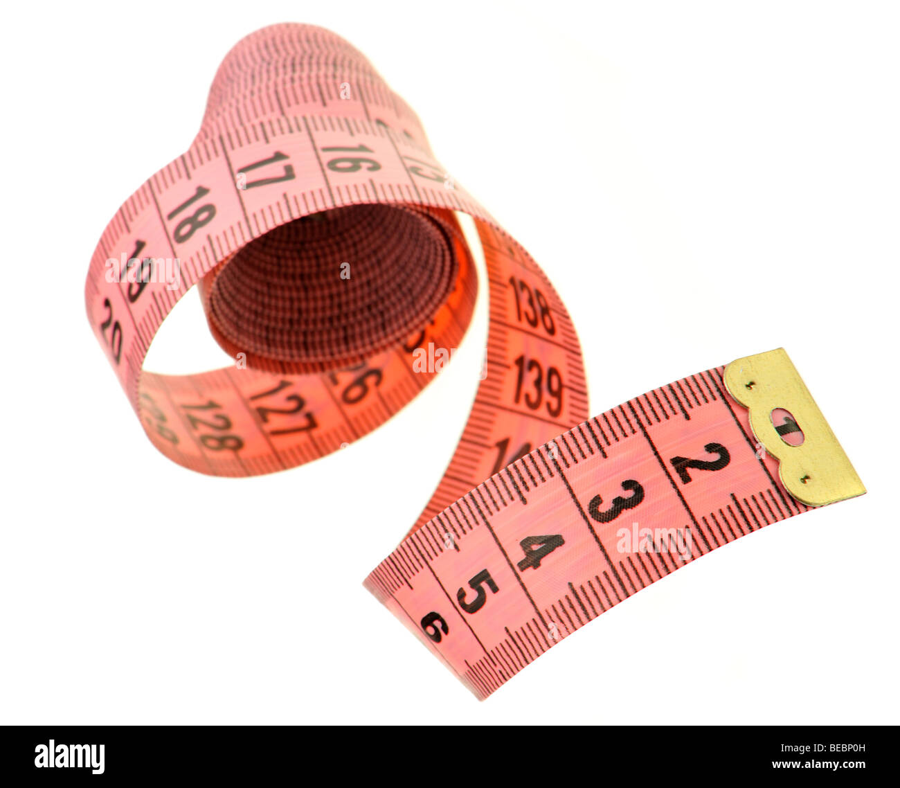 Measuring tape of the tailor red color. It is isolated on a white background Stock Photo
