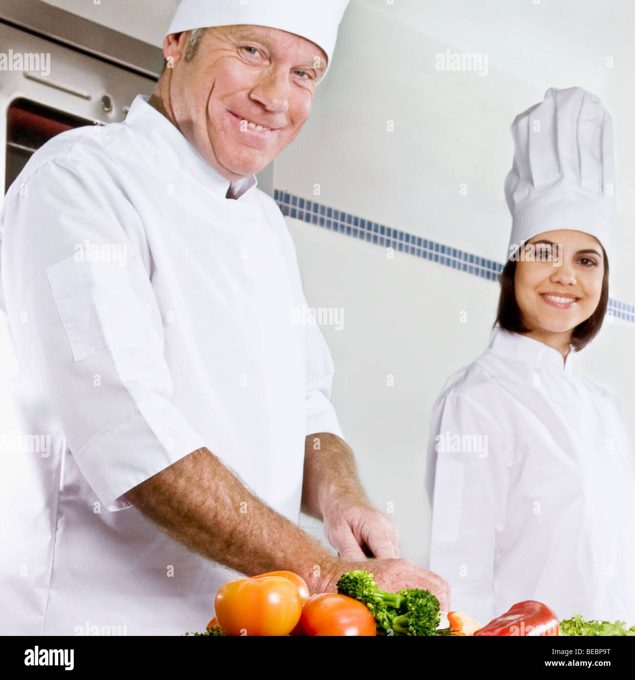 Chefs cooking food in the kitchen Stock Photo - Alamy