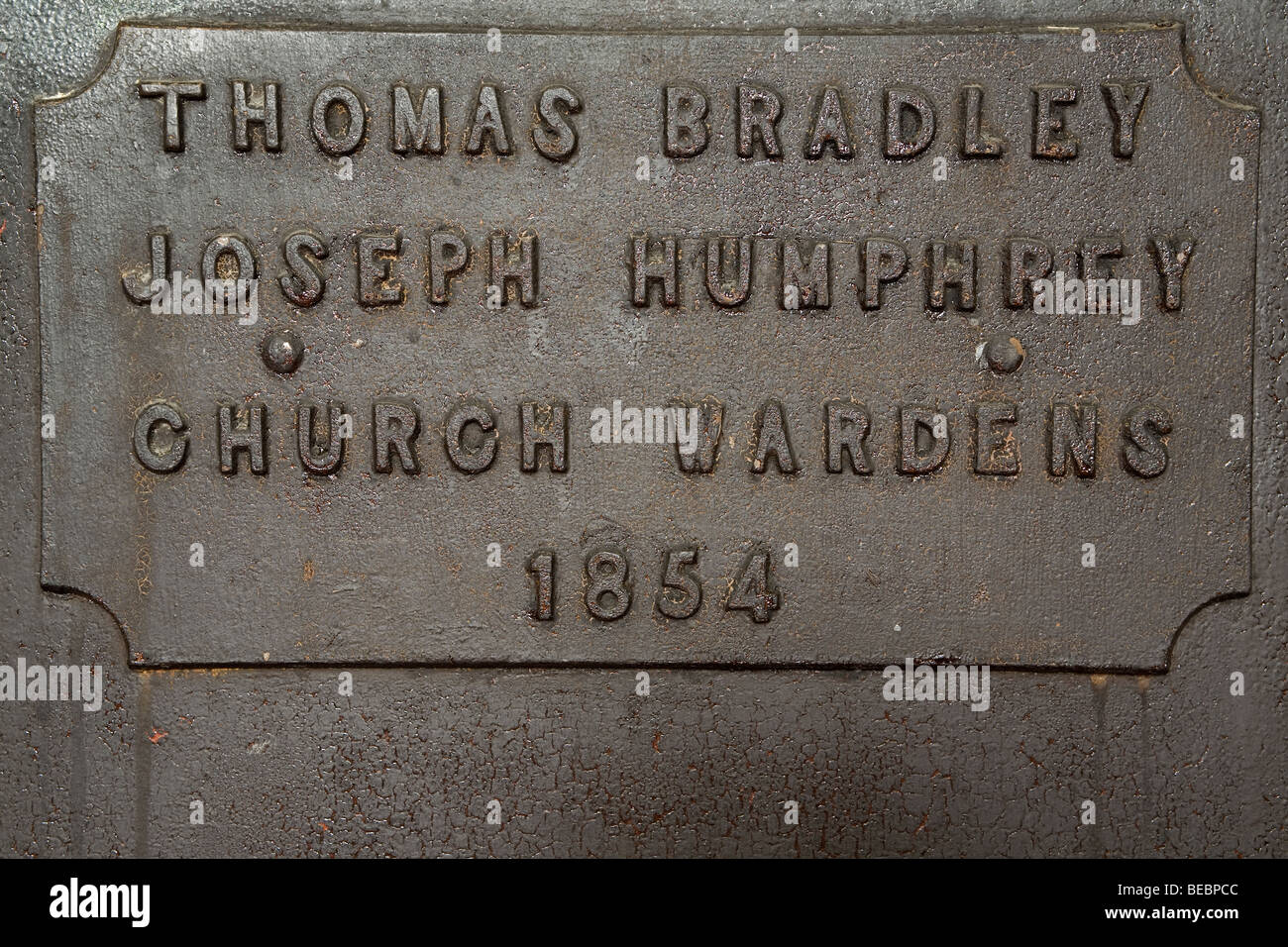 A plaque records the names of Church Wardens from the year 1854. They served in the Holy Trinity Church. Stock Photo