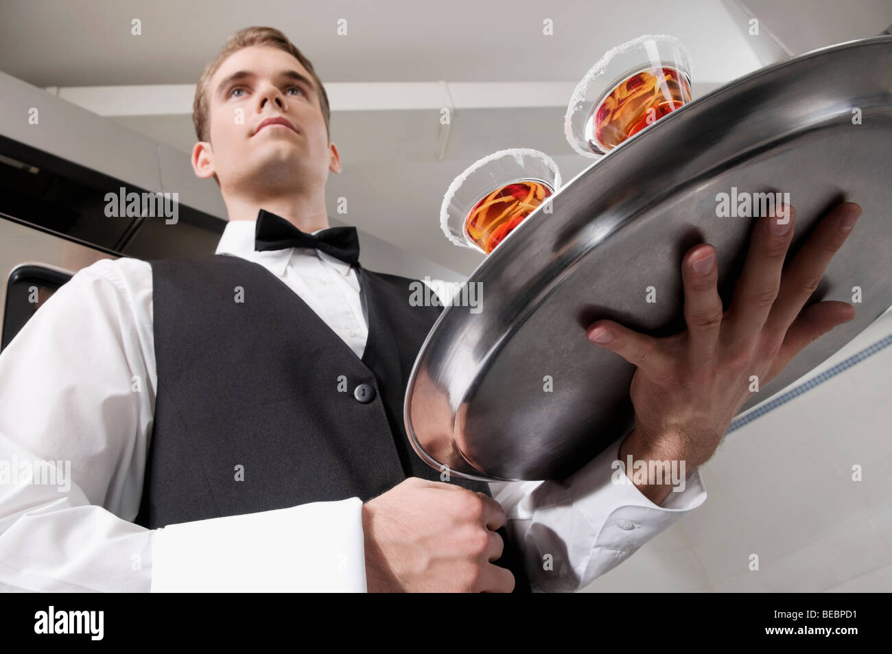 Waiter carrying silver tray hi-res stock photography and images - Alamy