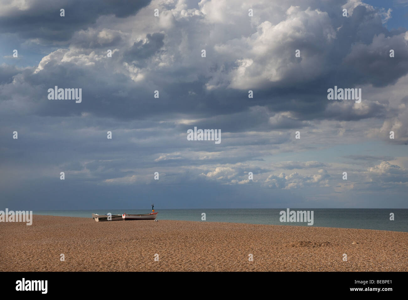 Crab boats pulled up on the shingle beach at Cley North Norfolk part of a National Nature reserve Stock Photo