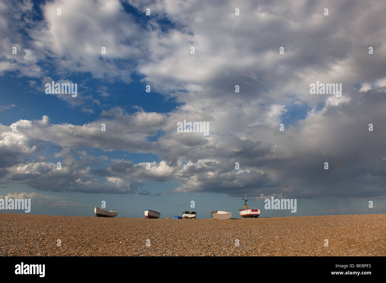 Crab boats pulled up on the shingle beach at Cley North Norfolk part of a National Nature reserve Stock Photo
