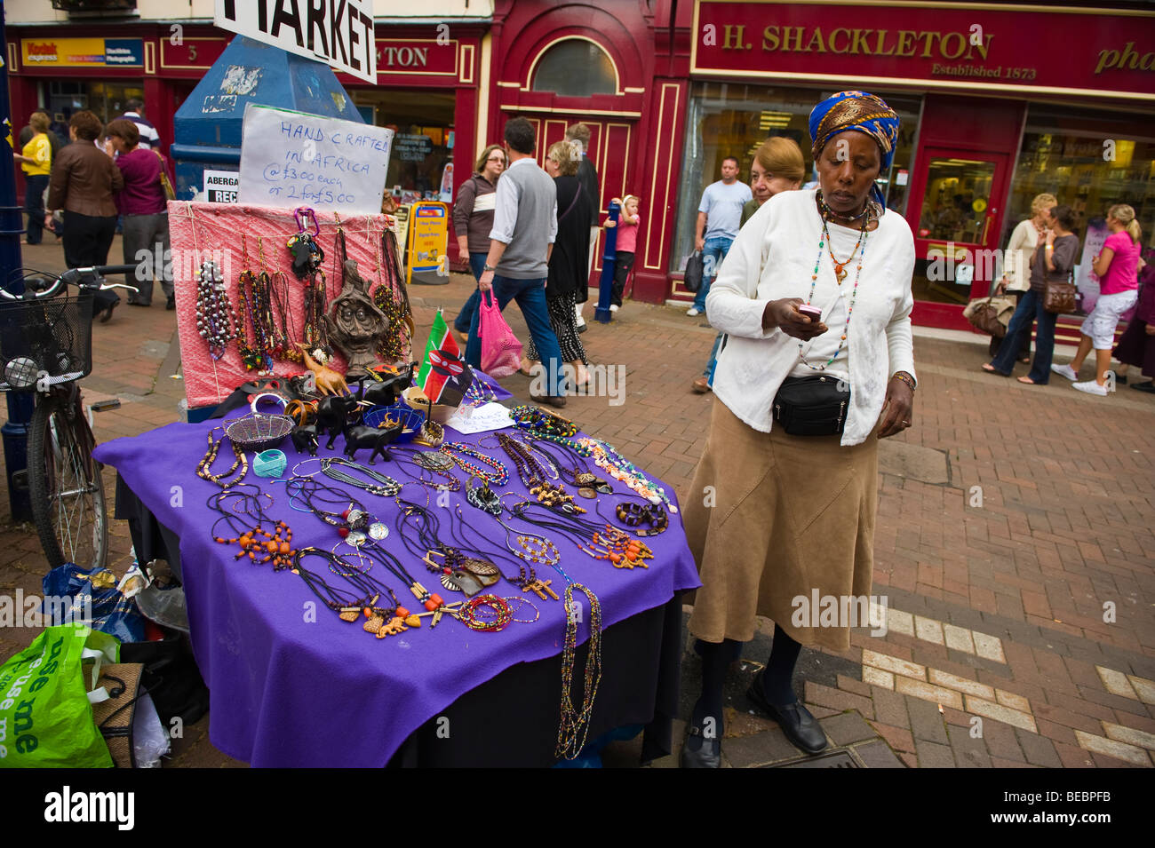 African woman selling hand crafts on street at Abergavenny Food Festival Monmouthshire South Wales UK Stock Photo