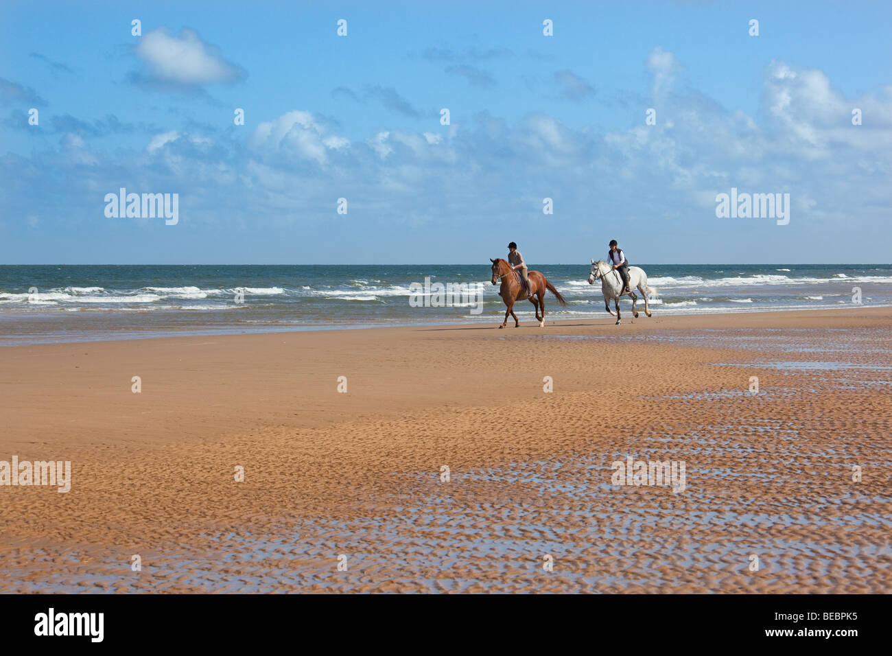 Holkham Beach Norfolk Horse Riding along the sand Stock Photo