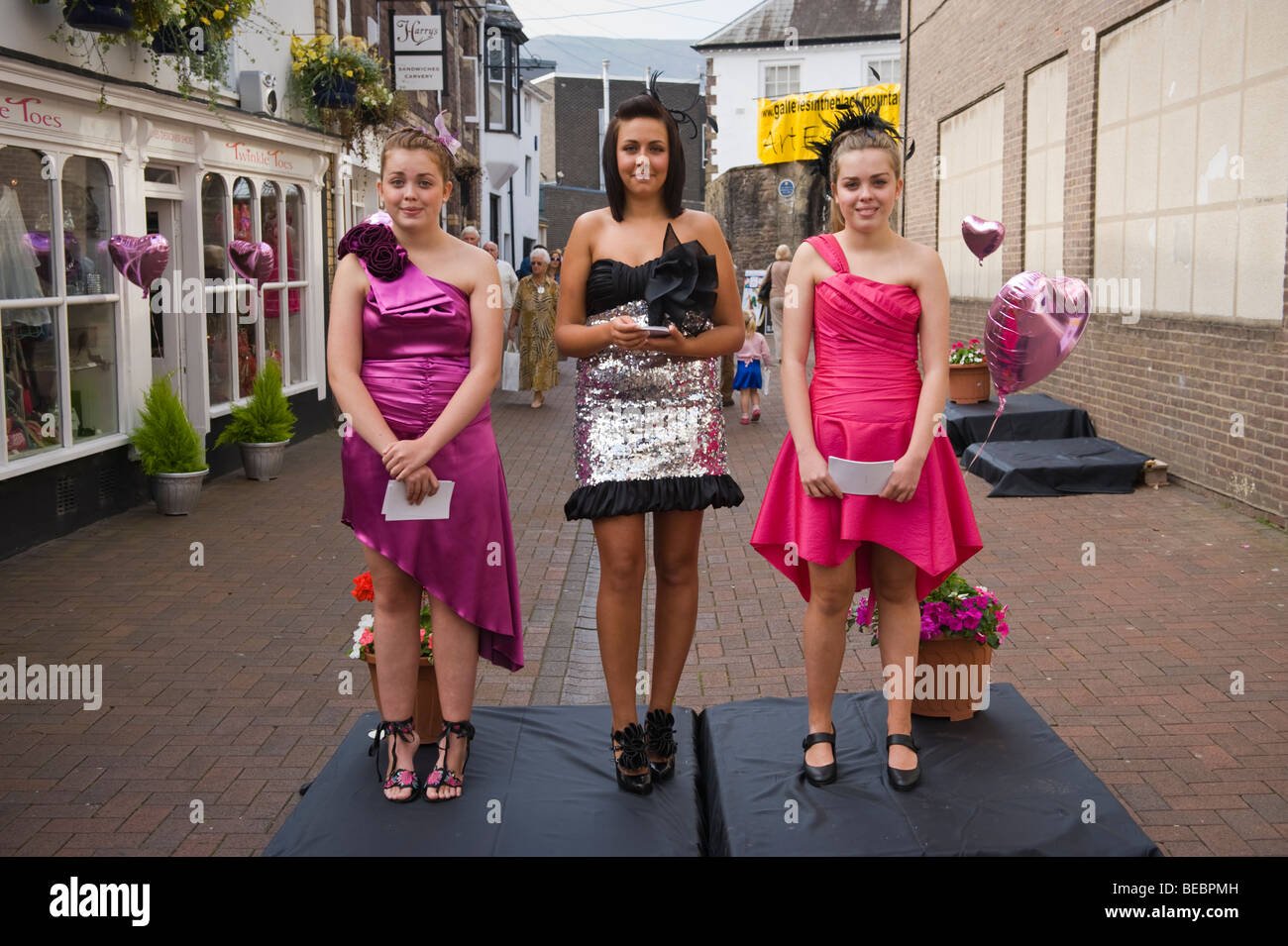 Made up teens on street outside beauty salon during Abergavenny Food