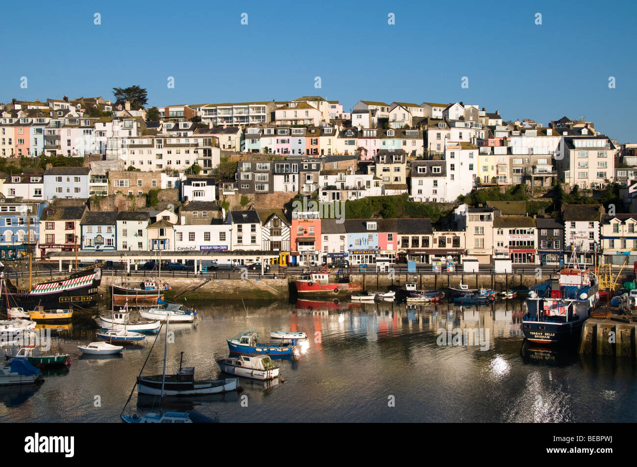 Houses on the hill and moored boats, Brixham Harbour, Devon, UK Stock Photo