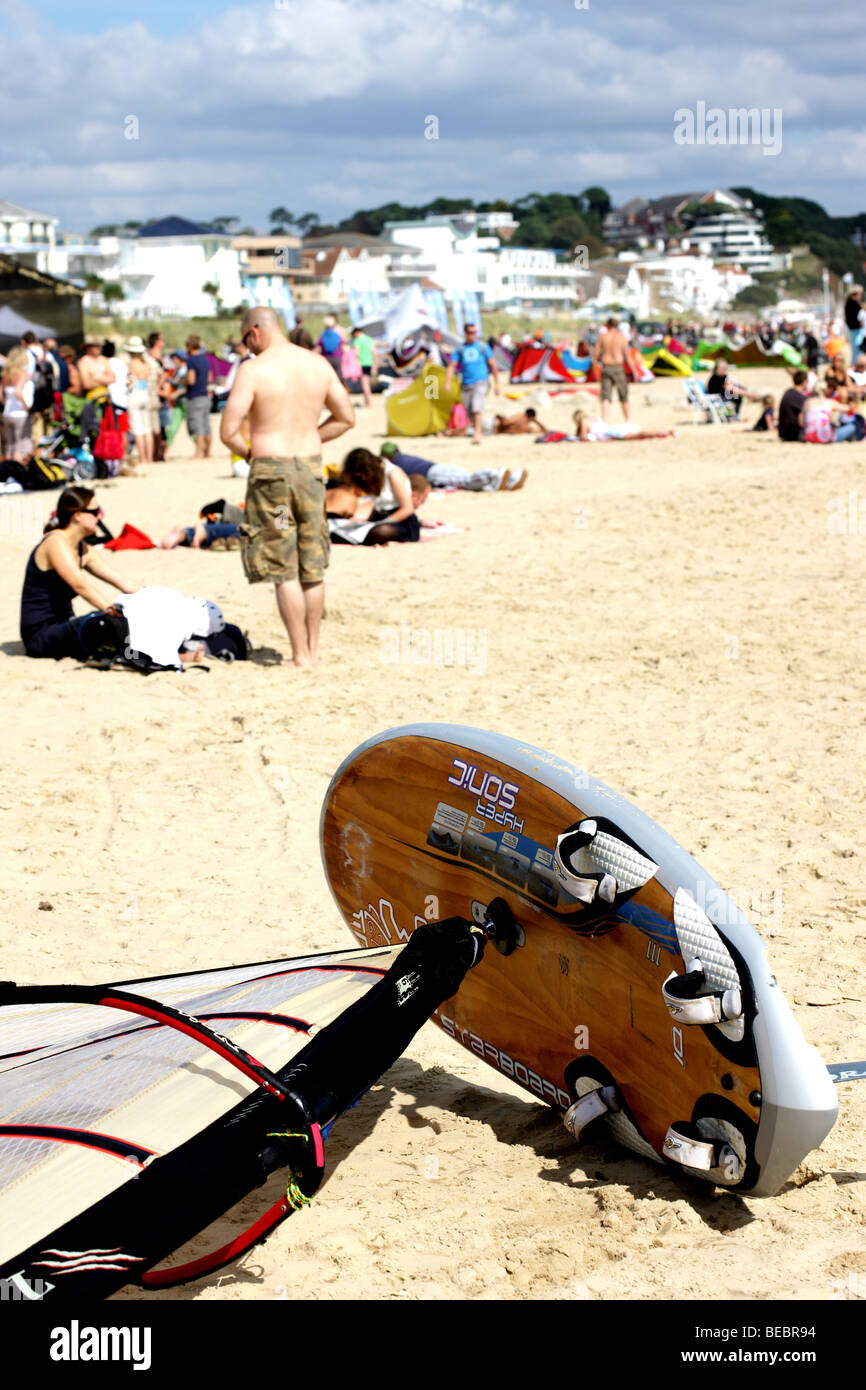 Colourful Windsurfing Boards And Sails Laying On A Sandy Beach Waiting