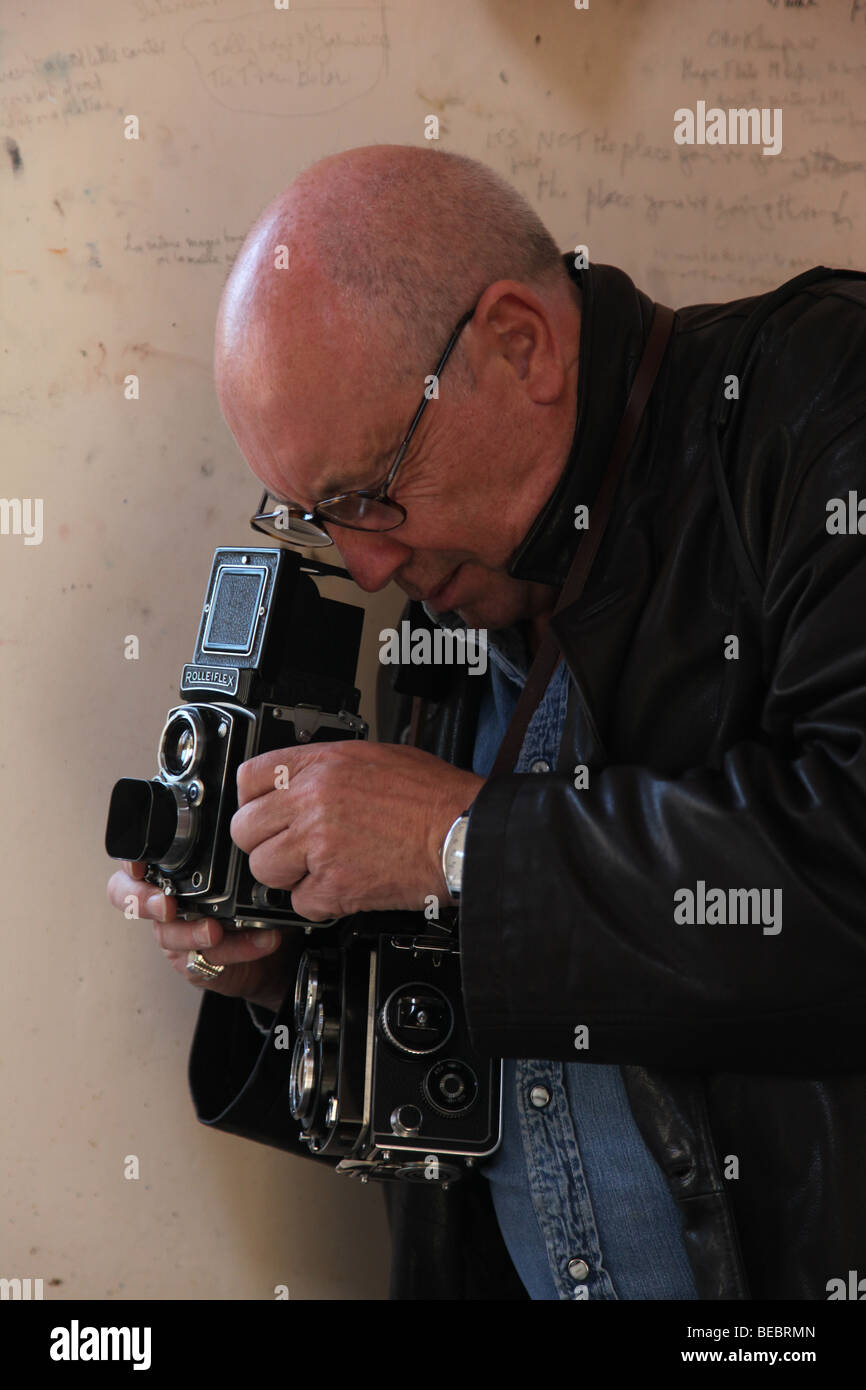 John Minihan shooting with his Rolleiflex camera Stock Photo