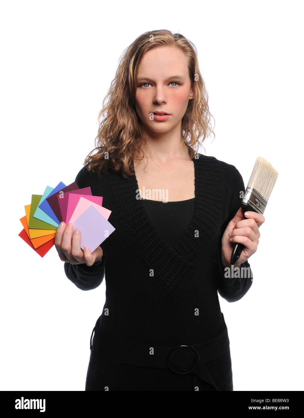 Woman Holding brush and color swatches isolated over white background Stock Photo