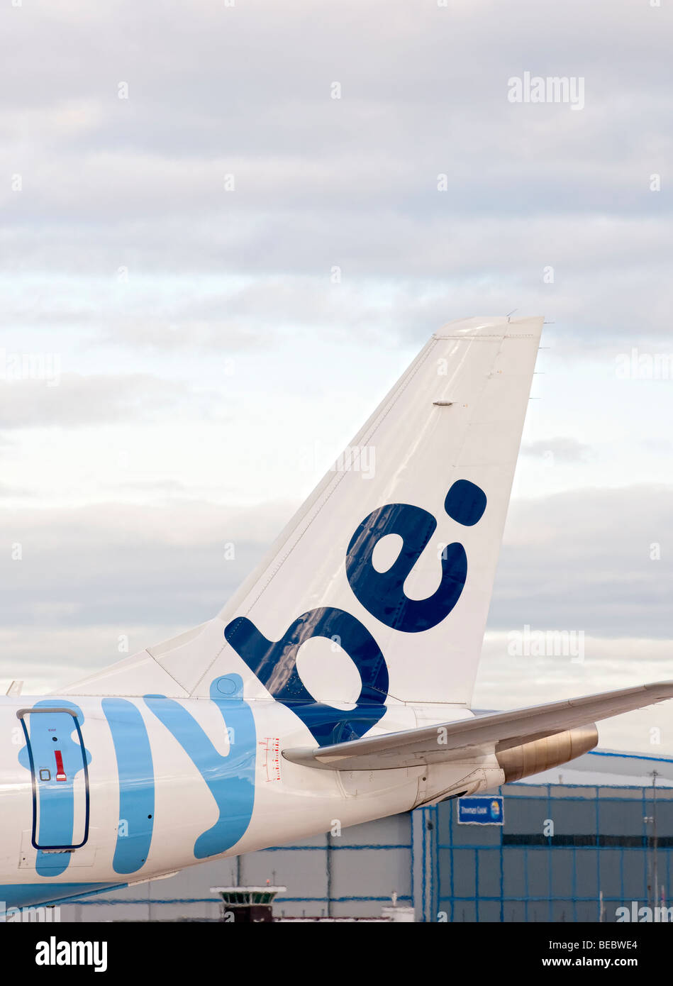 Tail fin of a FlyBE aircraft as it taxis for take off from Manchester Airport (Ringway Airport) in Manchester, England Stock Photo