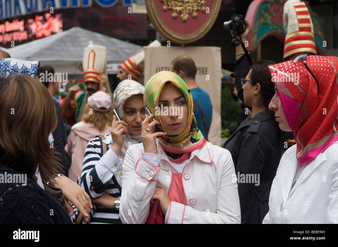 Women with headscarfs, some on their cell phones, at a Turkish Festival in New York Stock Photo