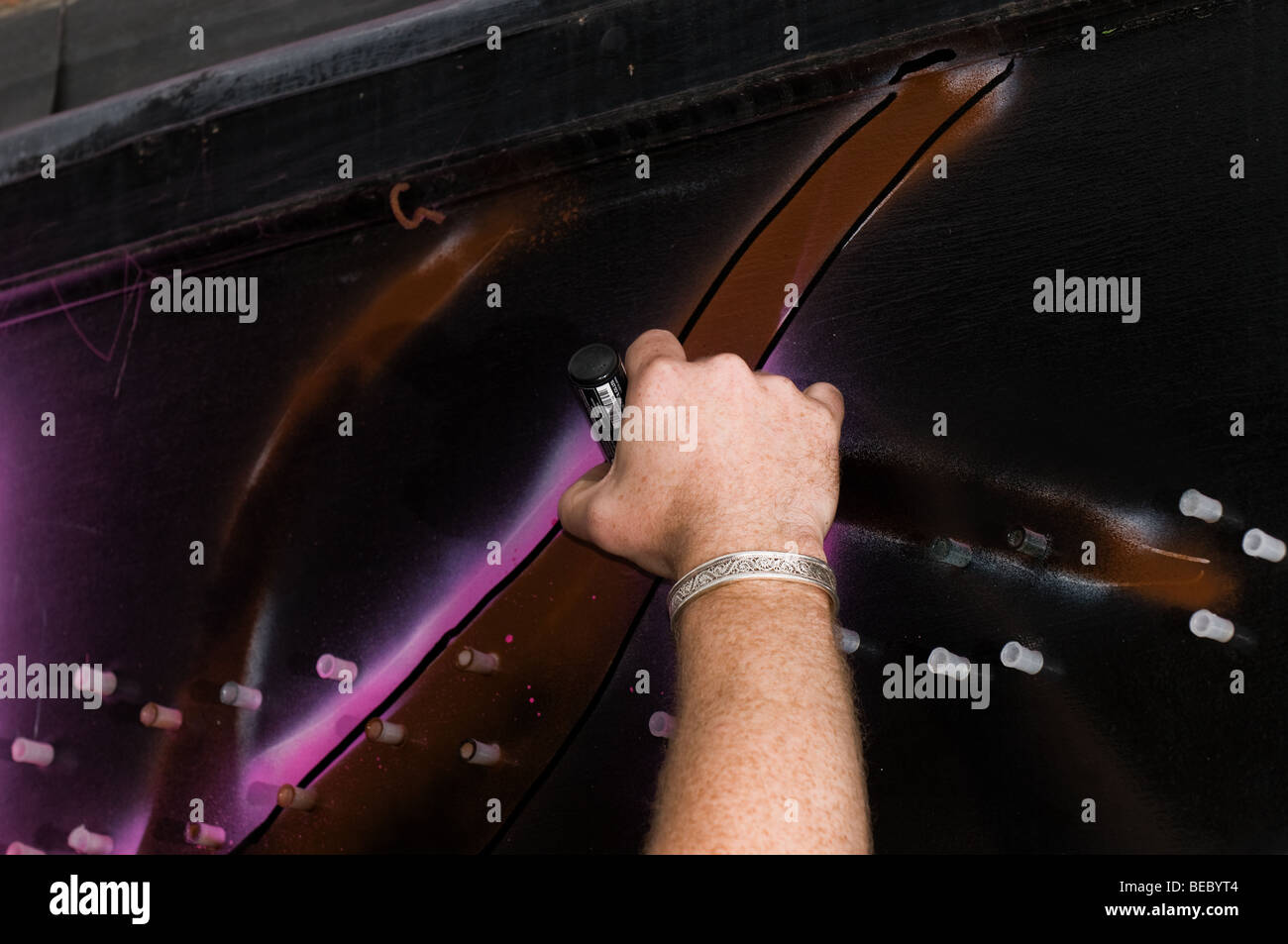 The hand of Tom Lewis street artist working on a mural in Chelmsford in Essex.  Photo by Gordon Scammell Stock Photo
