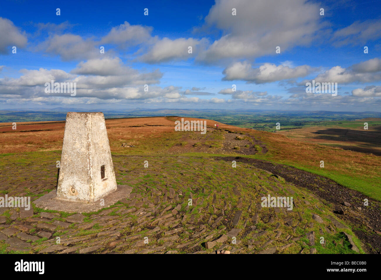 Walkers approaching the Trig point on the summit of Pendle Hill Pendle Lancashire England UK