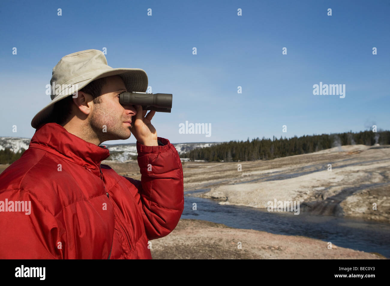 Tourist looking through binoculars, Yellowstone National Park, USA Stock Photo Alamy