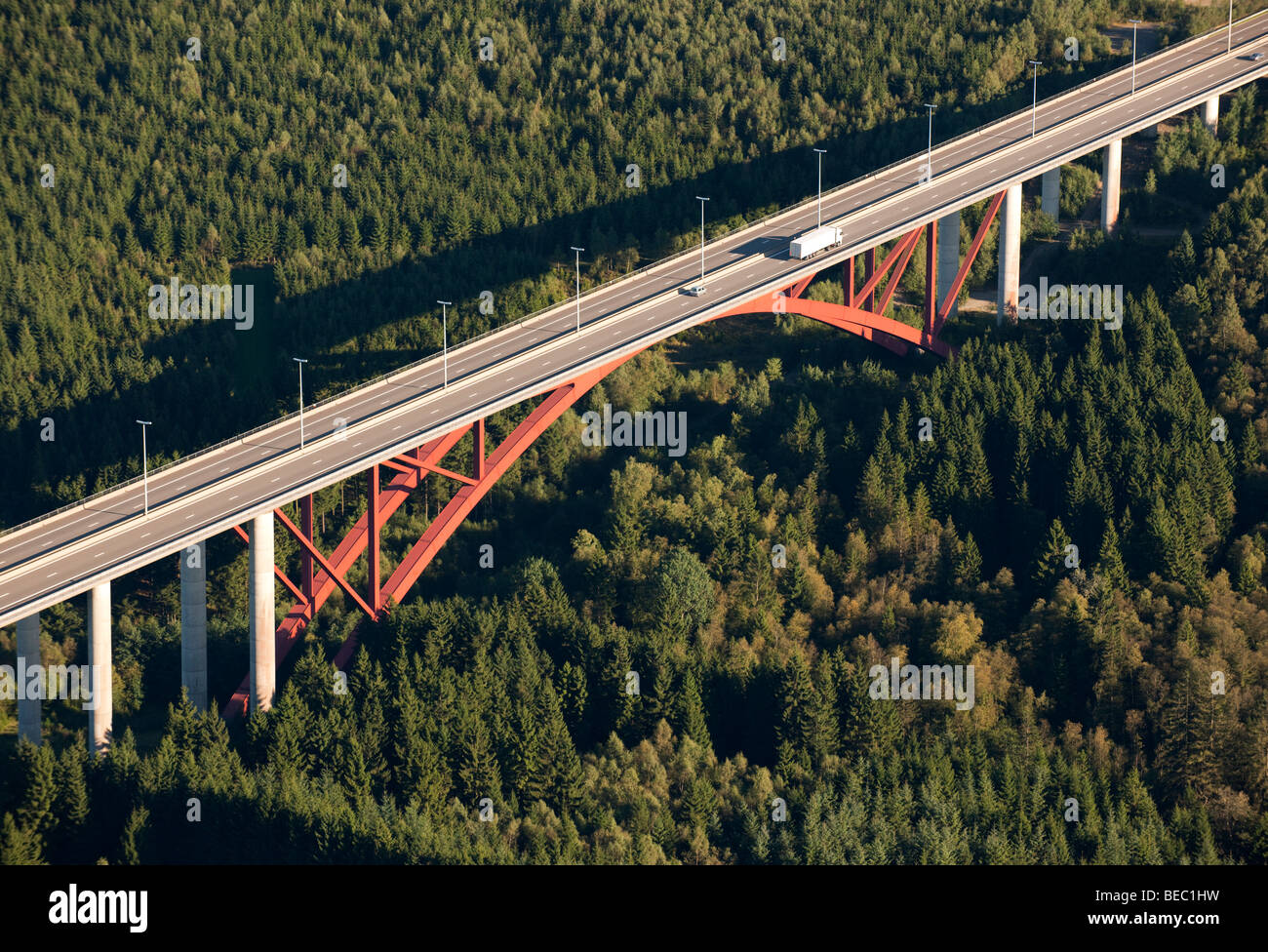 Aerial view : Red highway bridge crossing a big forest Stock Photo