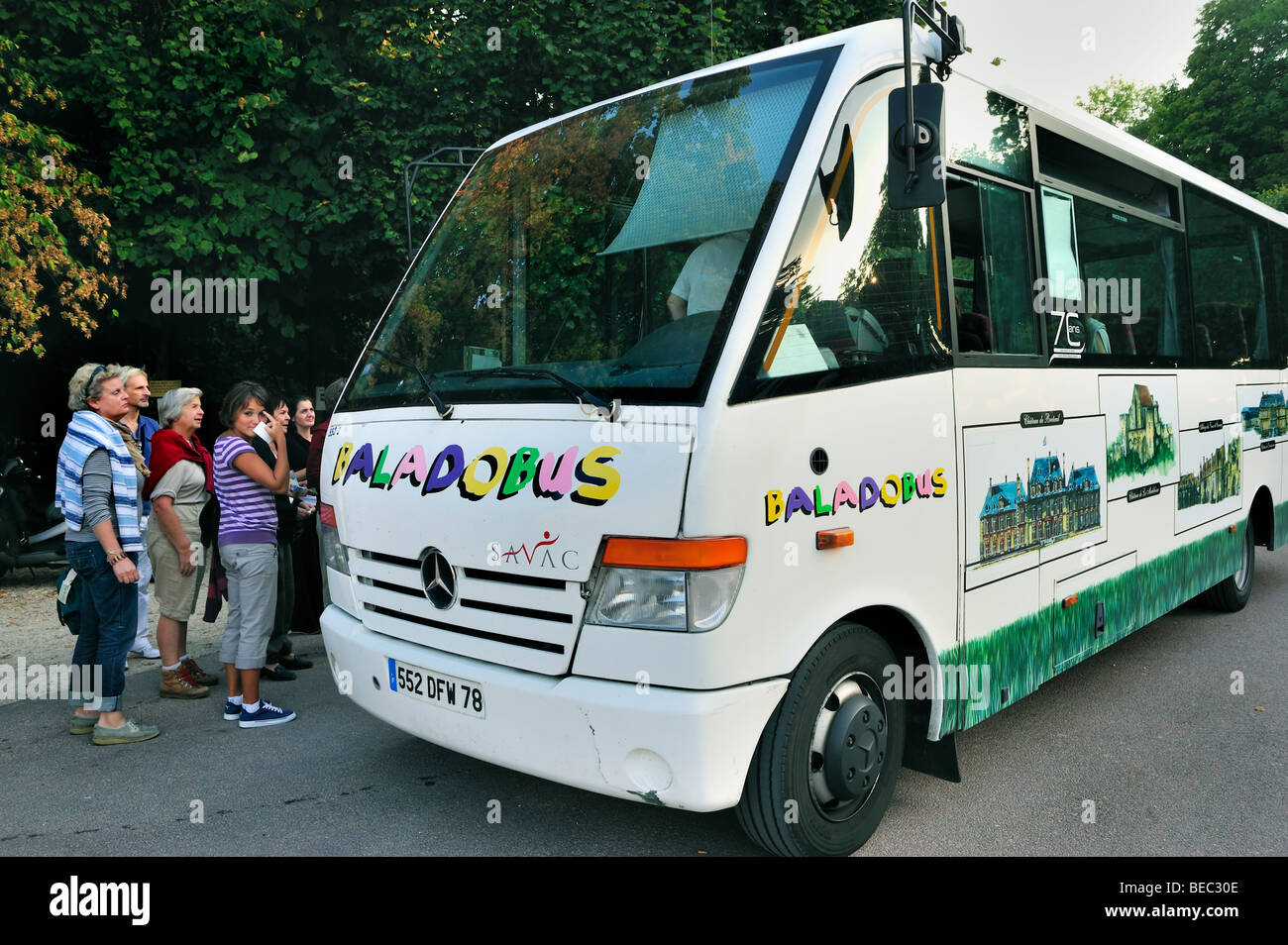 Paris, France - Group Tourists Visiting French Monument,  Local Tour Bus, Baladobus, Stock Photo