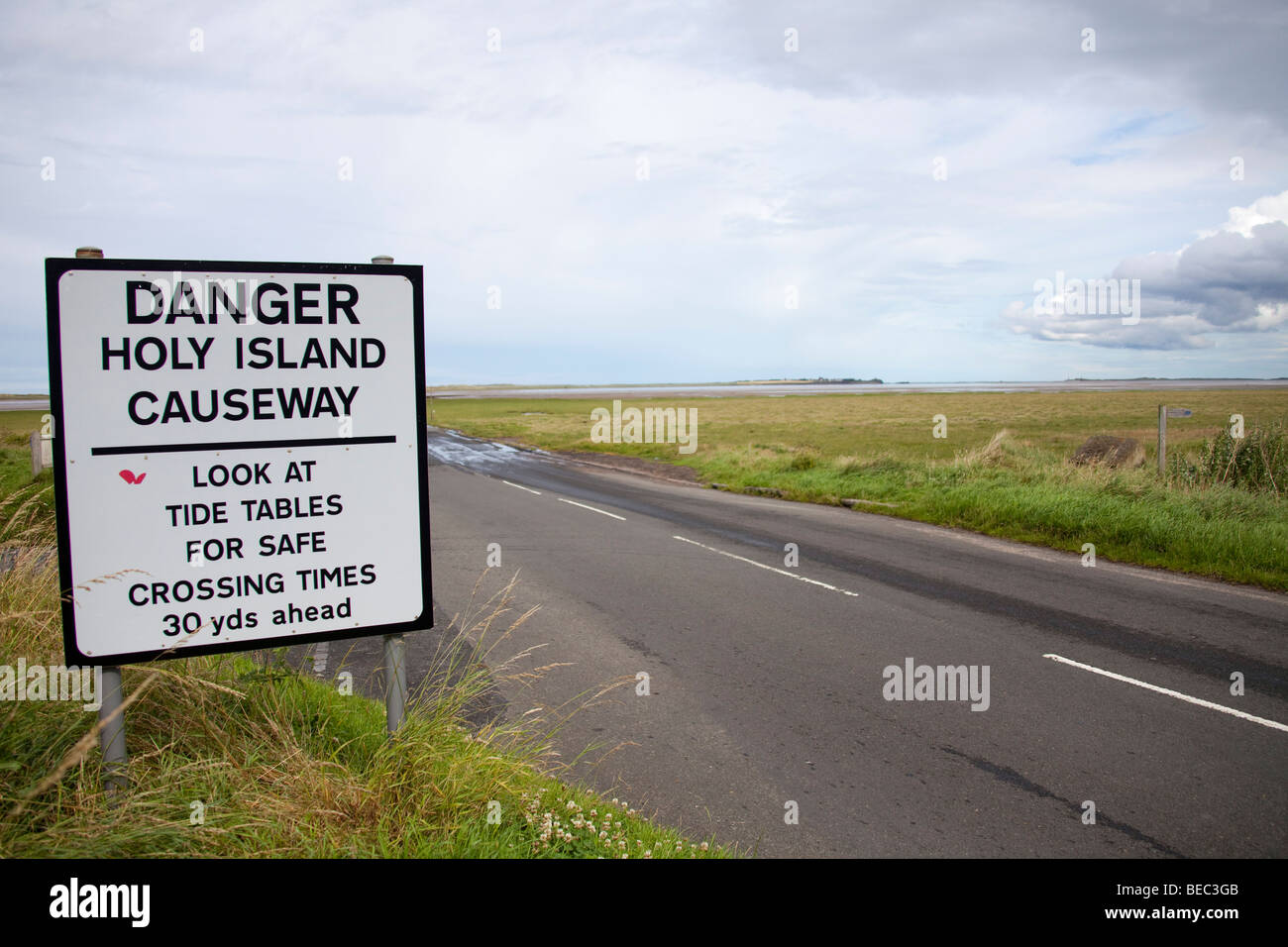 Causeway tide sign warning at Lindisfarne Holy Island UK Northumberland.96944 Holy Island Causeway Stock Photo