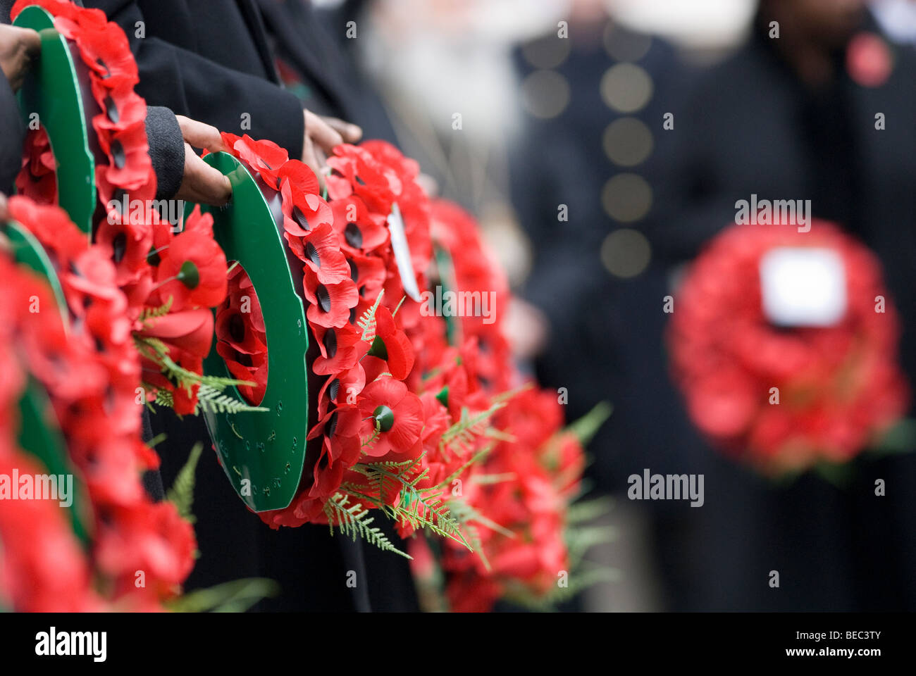 People holding poppy wreaths on remembrance Sunday at the Cenotaph ...