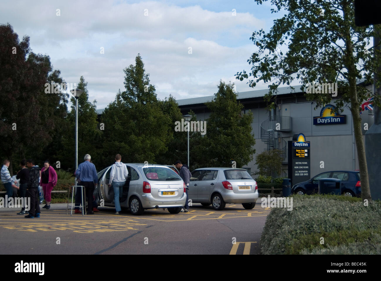 People getting into a car at the South Mimms service station on the M25 motorway. Stock Photo