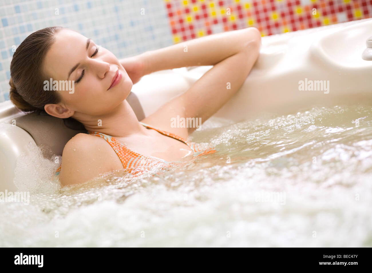 Young woman relaxing in whirlpool. Stock Photo