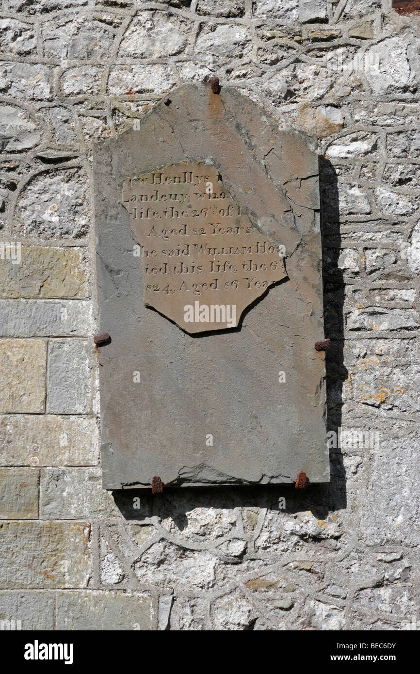 Slate memorial plaque on the outside of  St Rhidian and St Illtyd church at Llanrhidian on the Gower peninsular in Wales. Stock Photo