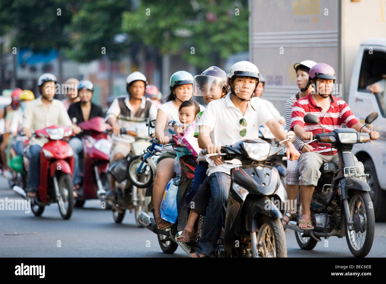 People riding scooters/mopeds in Vietnam in Hanoi Stock Photo