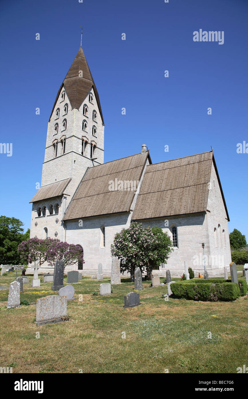 Stone church with graveyard at Tingstäde Träsk in the northern part of the Swedish island Gotland in the Baltic Sea. Stock Photo