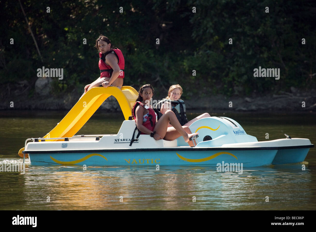 Three teenage girls having a good time in a paddle boat Stock Photo
