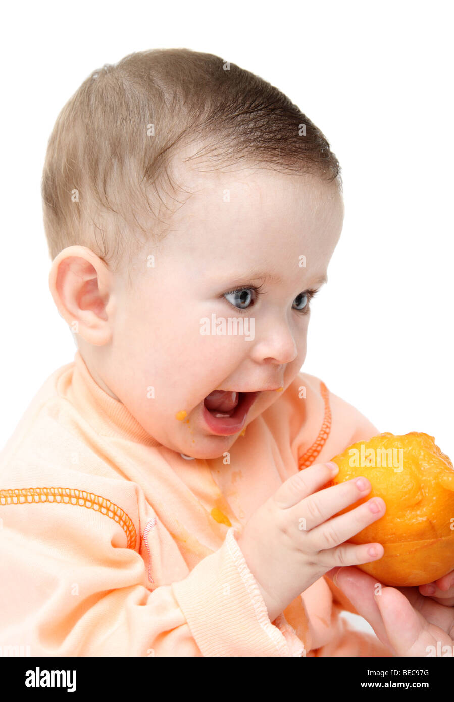 sitting baby eating peach isolated on white Stock Photo Alamy