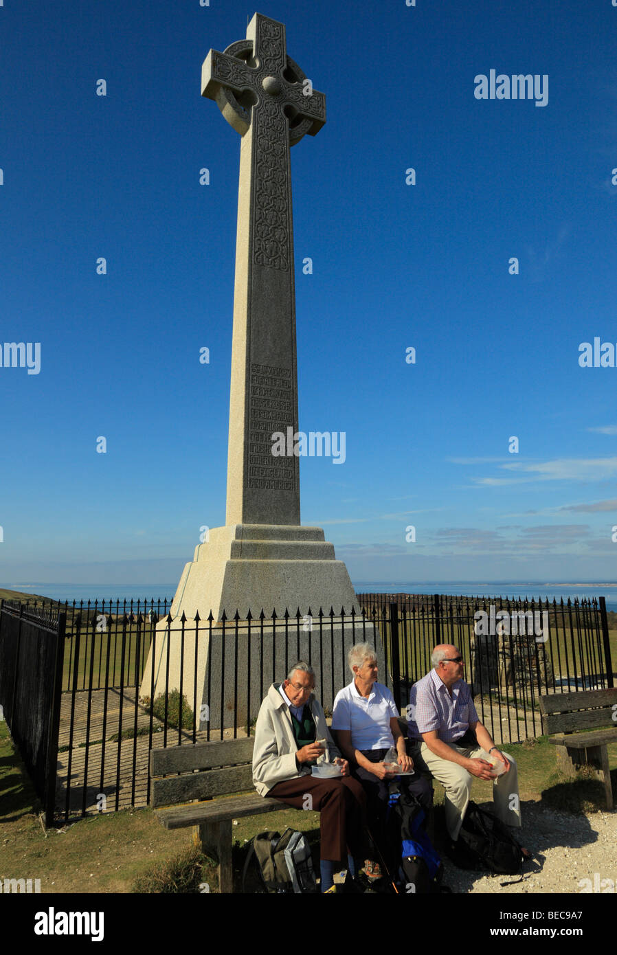 Elderly people sitting beside the Tennyson Monument. Tennyson Down, Isle of Wight, England, UK. Stock Photo