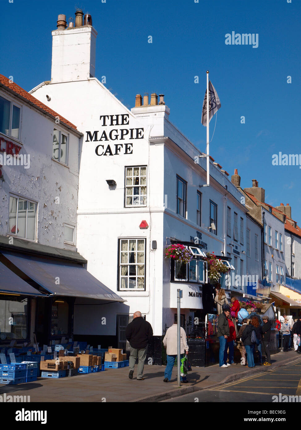 A queue on the steps waiting for fish and chips at the famous Magpie Café in Whitby North Yorkshire Stock Photo