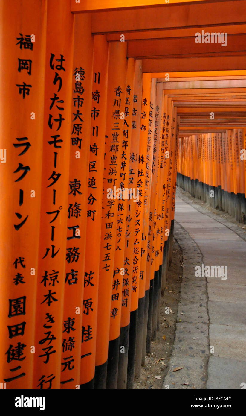Vermilion torii (gate) with kanji inscriptions at Fushimi Inari Taisha