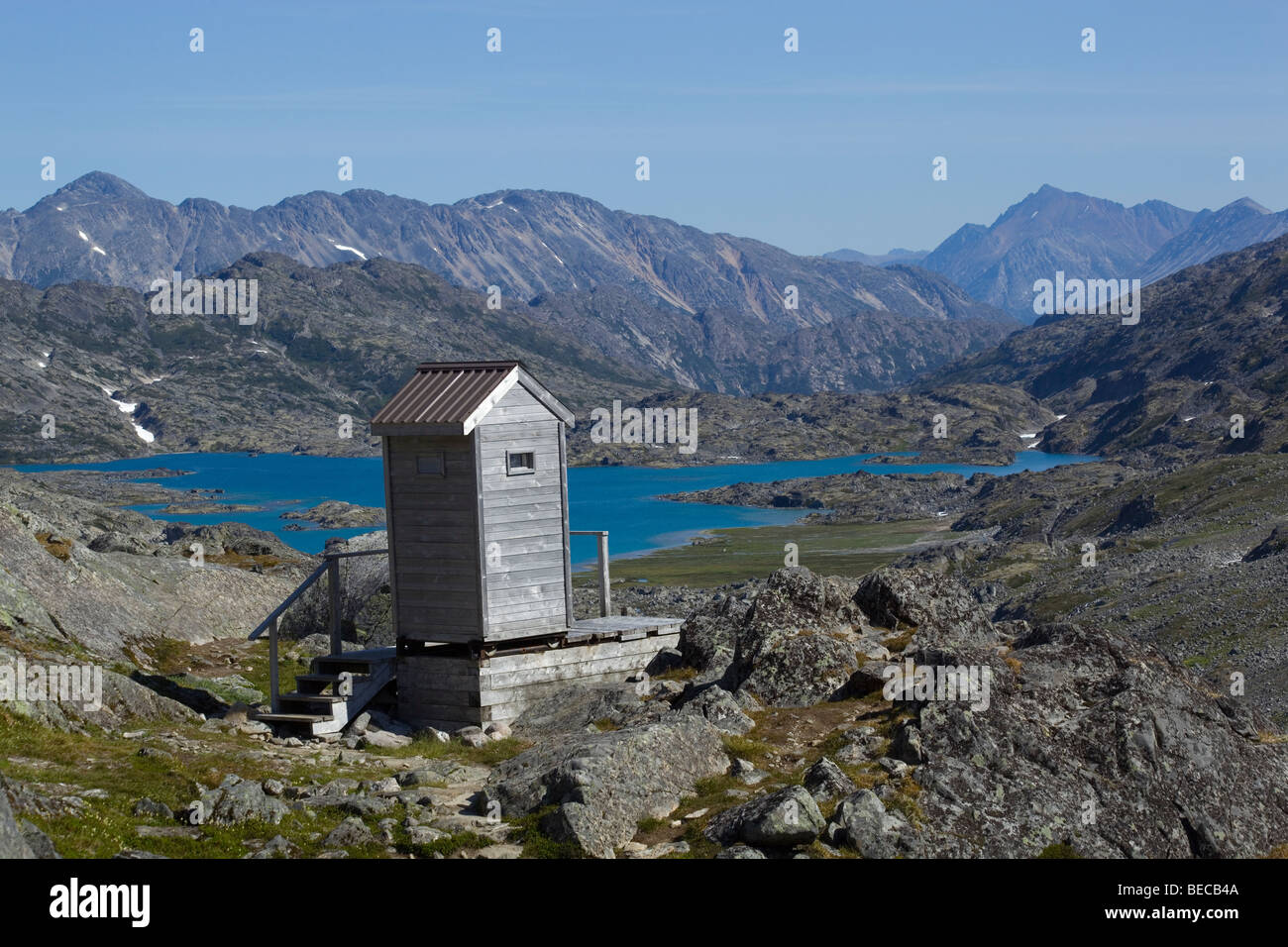 Outhouse with scenic view on summit of historic Chilkoot Pass, Chilkoot Trail, Crater Lake behind, Yukon Territory, British Col Stock Photo