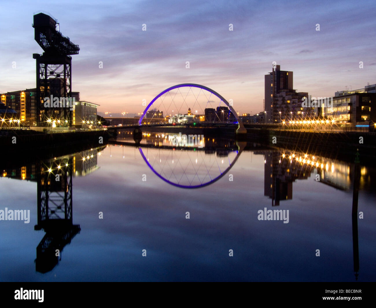 Sunrise over the river Clyde with view of illuminated Clyde Arc, Glasgow Stock Photo