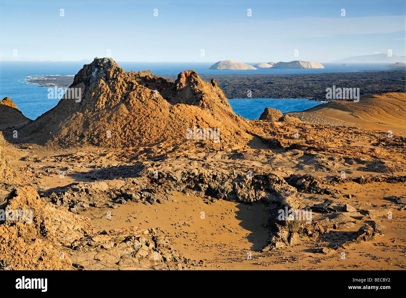 Primeval volcanic scenery with small crater, Bartolomé Island, view to Santiago, Galapagos Achipelago, UNESCO World Heritage Si Stock Photo