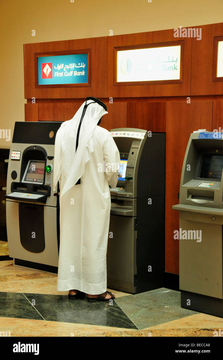 Arabs with Dishdasha, the typical white gown, at an ATM, Mall of the