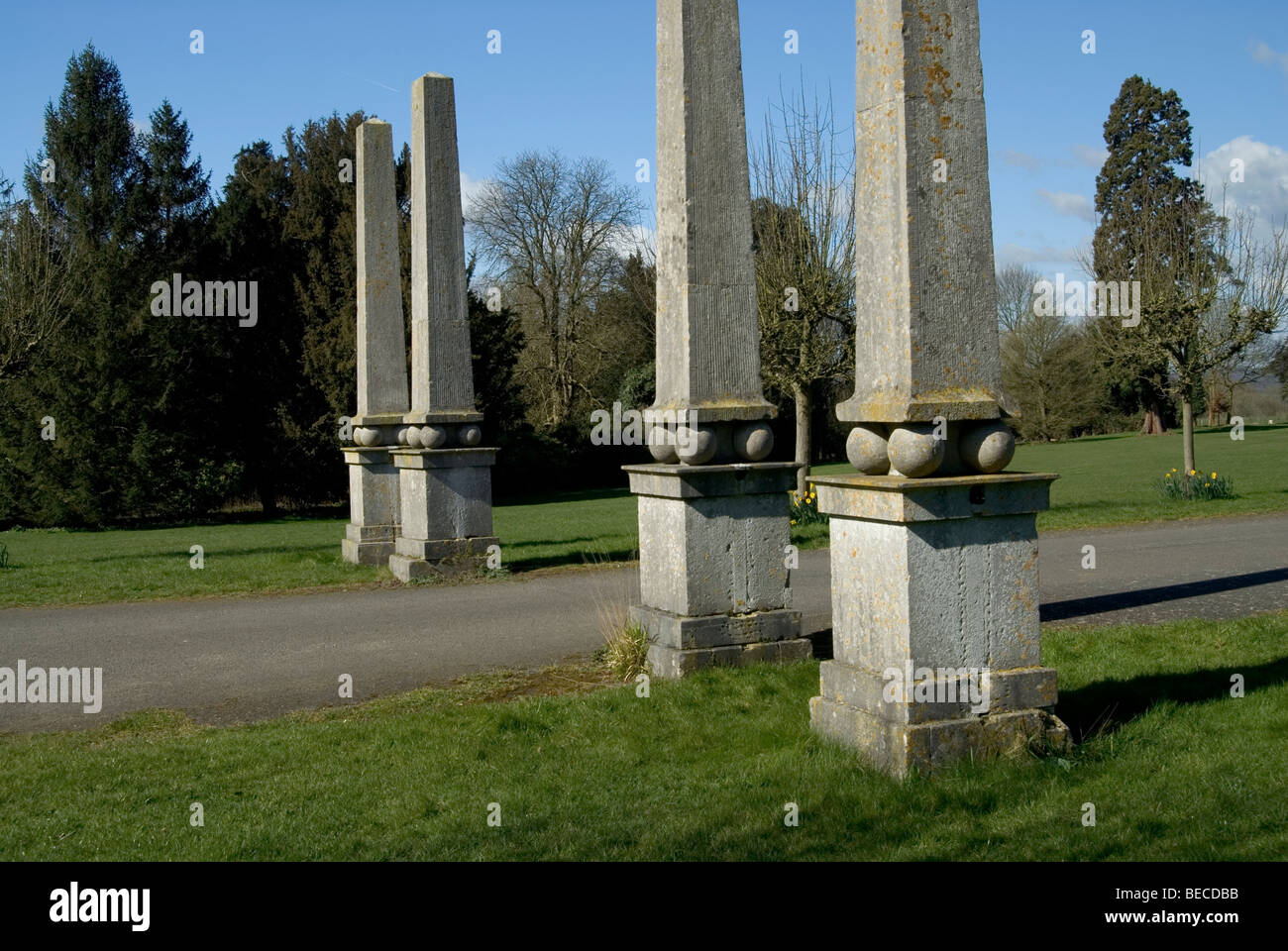 landscape view of four columns in a row either side of a road Stock Photo