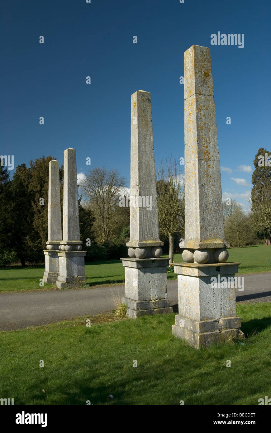 Four square columns in a row in parkland with blue sky on a fine day Stock Photo