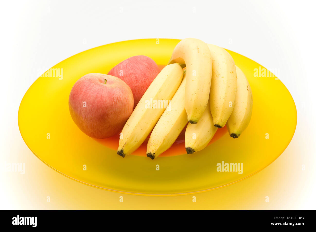 Apples and bananas in a glass bowl Stock Photo