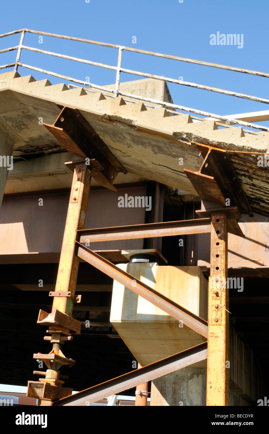 Supports holding up a decaying cement stairway Stock Photo