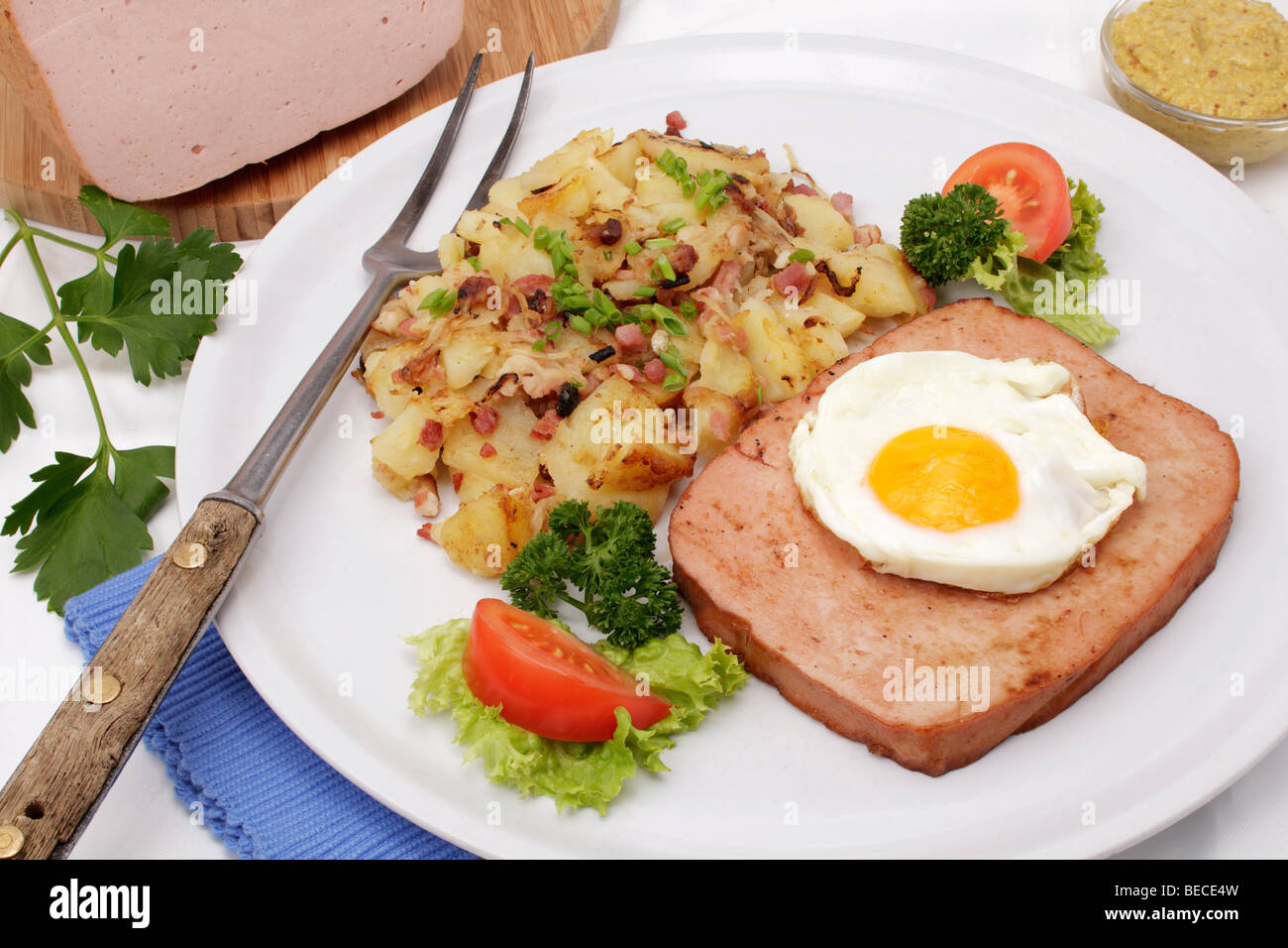 Leberkaese with fried egg and fried potatoes, Bavarian speciality Stock Photo