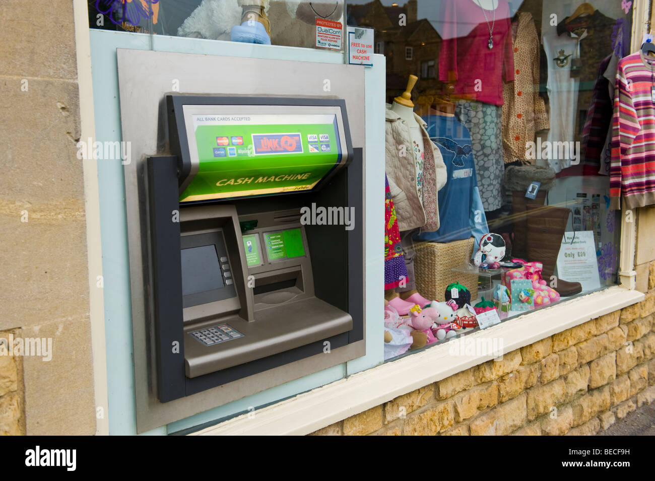 Cash Machine in shop window in Cotswold village of Bourton on the Water Gloucestershire England UK Stock Photo