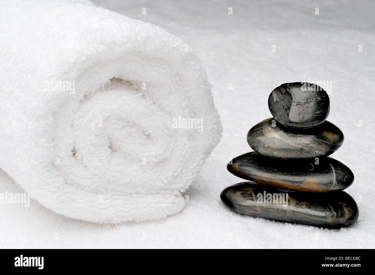 Spa towel with dark spa stones Stock Photo