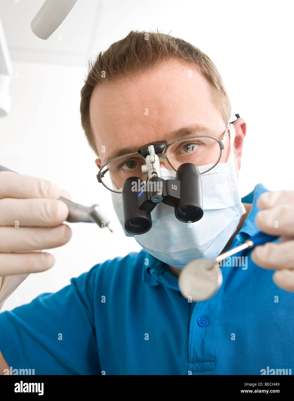 Dentist wearing magnifying glasses during treatment Stock Photo