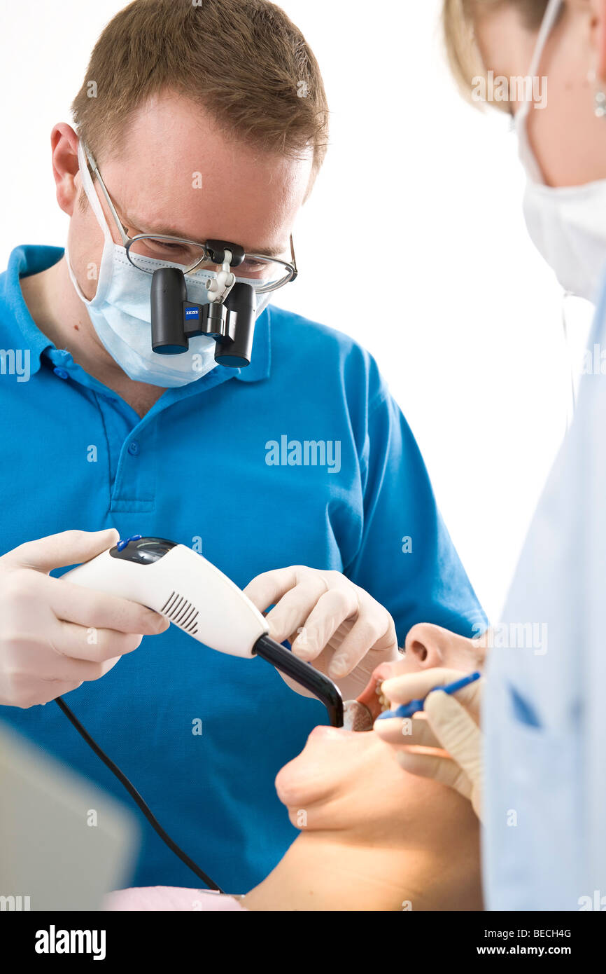Dentist and dental nurse treating a patient Stock Photo