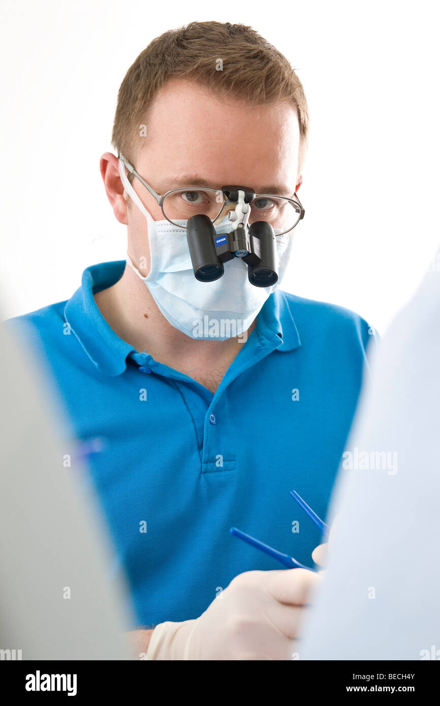 Dentist wearing magnifying glasses Stock Photo