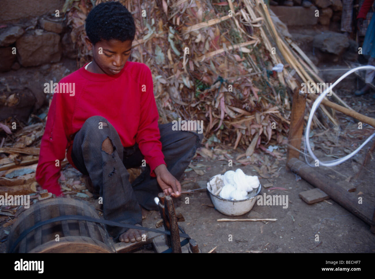 A boy spinning thread for weaving, Dalocha, Ethiopia Stock Photo - Alamy