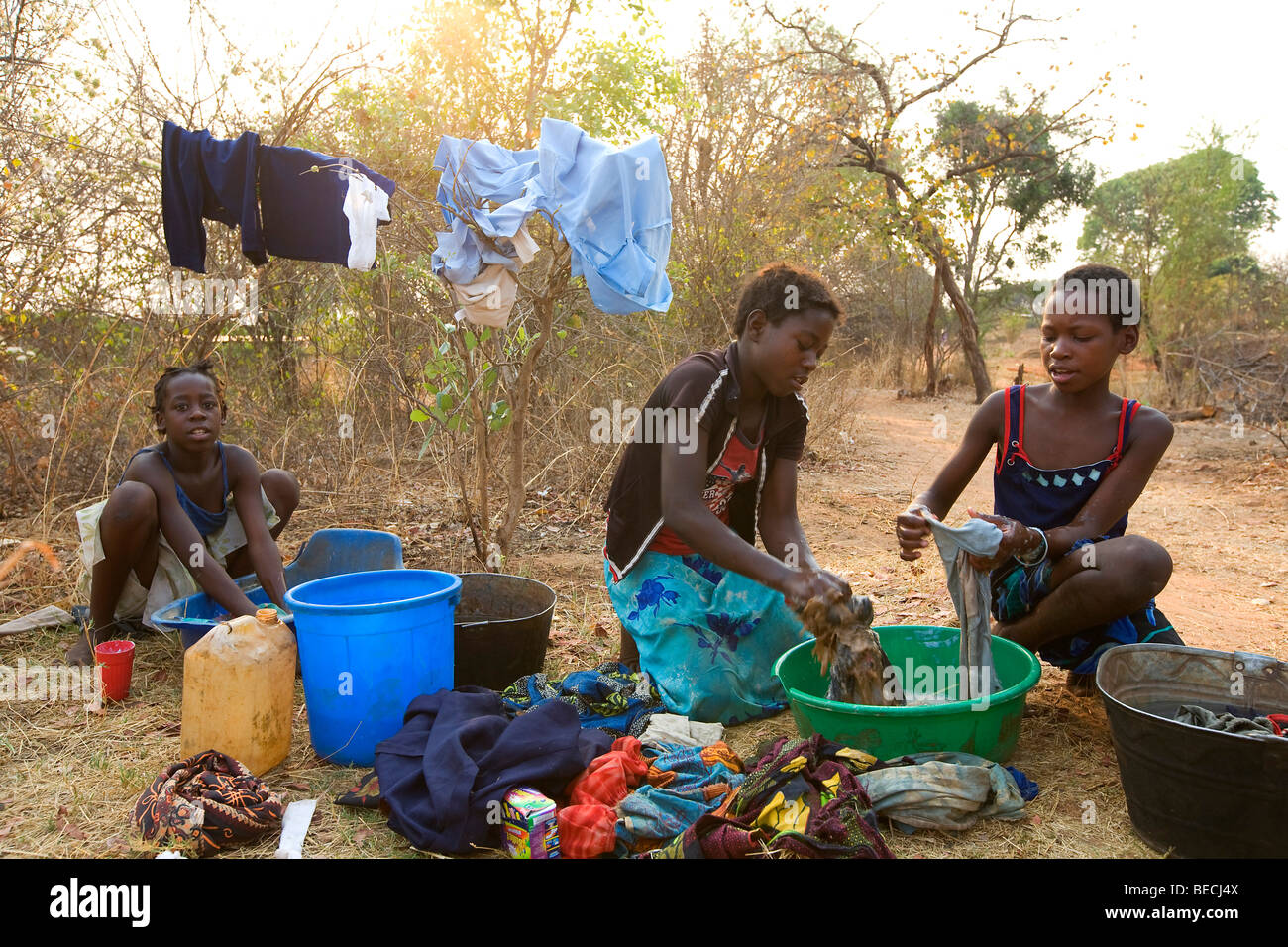 Teenagers washing clothes, washing square, African village Sambona